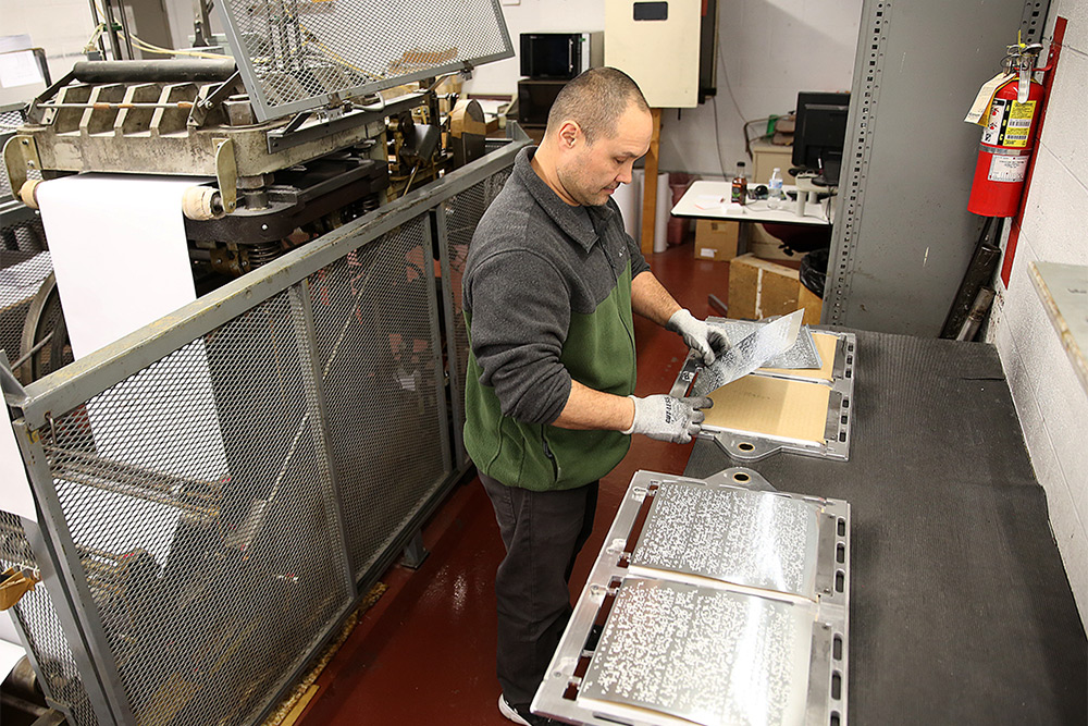 man working on Braille Printing House
