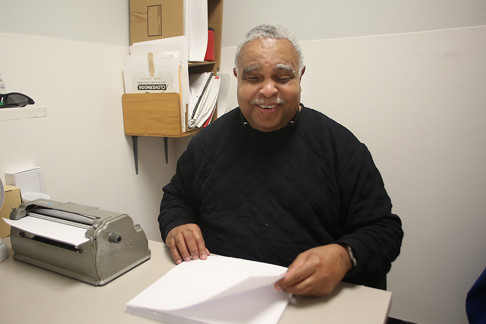 man who is visually impaired proofreading at Clovernook Center