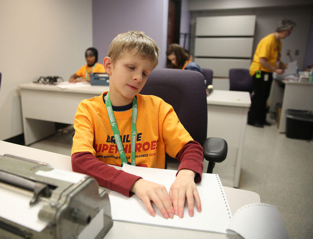 Philip Sotak participates in the Ohio Regional Braille Challenge, working his way through a proofreading test.