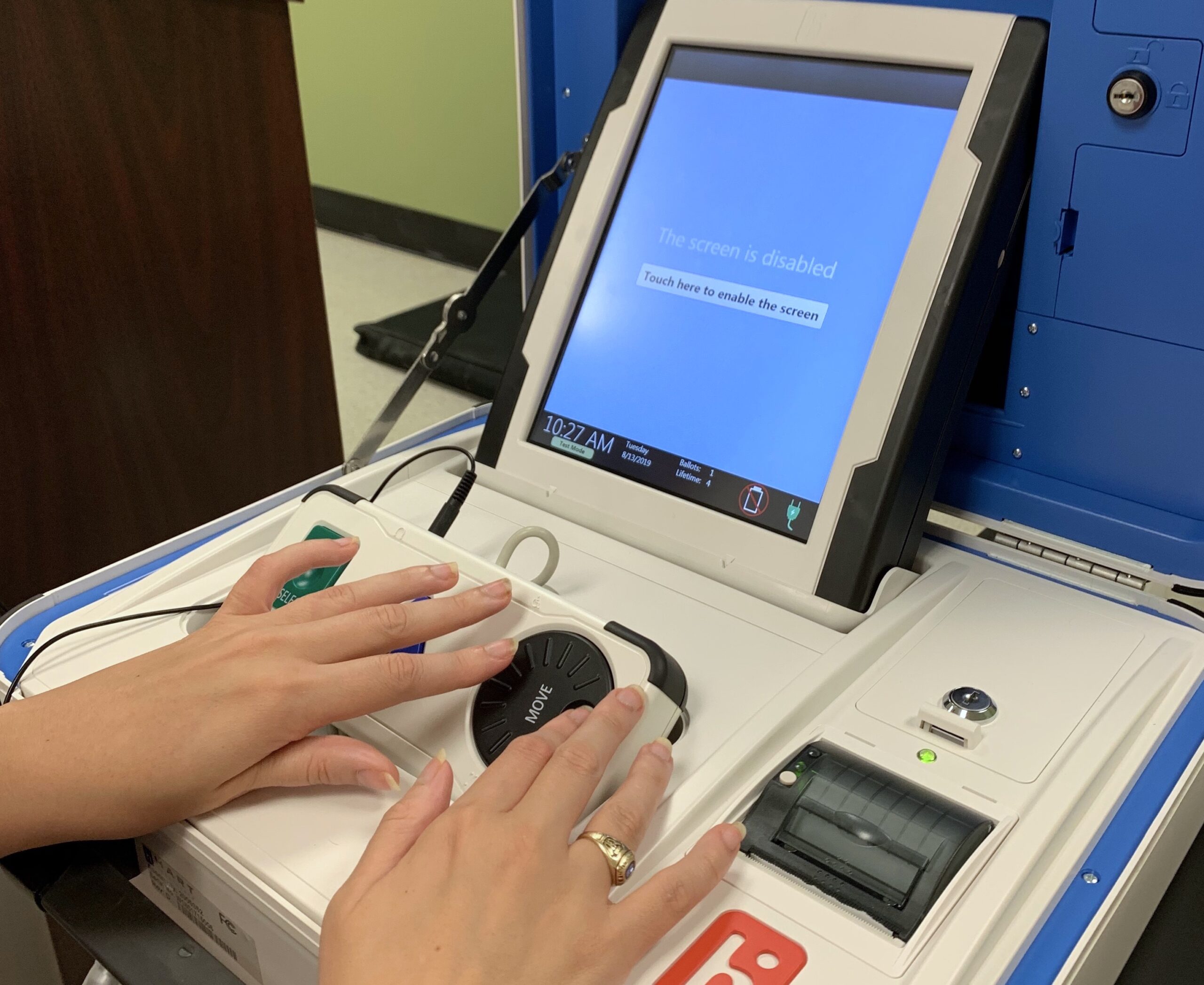 A Clovernook Center employee with visual impairment tests the new accessible voting machine at Clovernook Center.