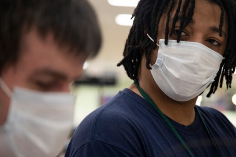 Sean wearing a mask looking at a Clovernook Client