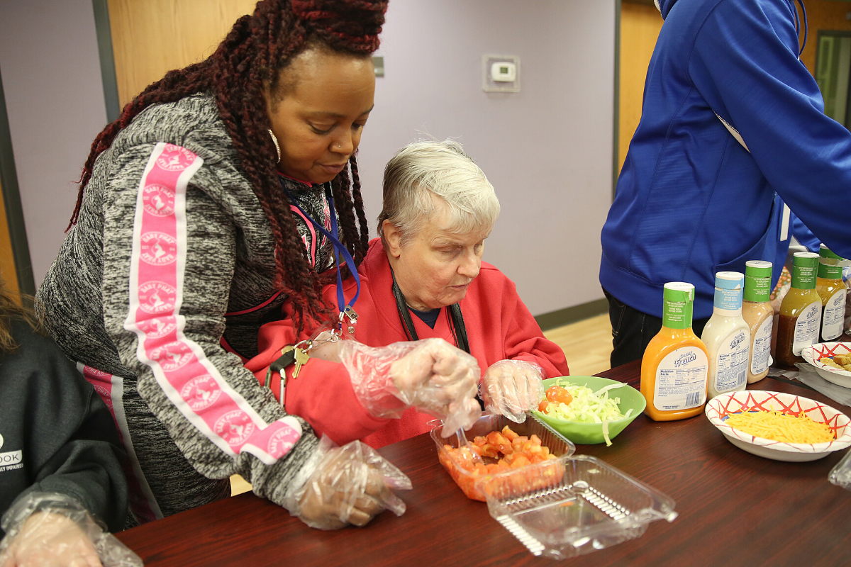 Clovernook staff person assisting a member of the Adult Day Program