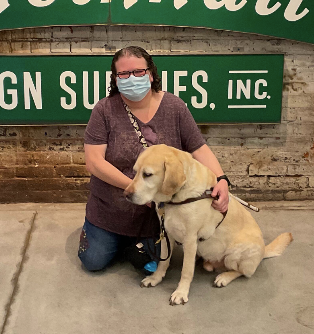Image of Deanna Lewis and her guide dog Mambo at the American Sign Museum