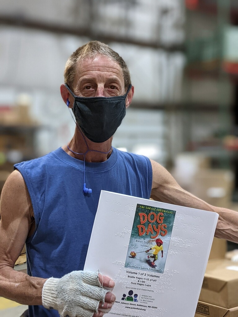 Jeff Broz holding Braille Book, Dog Days