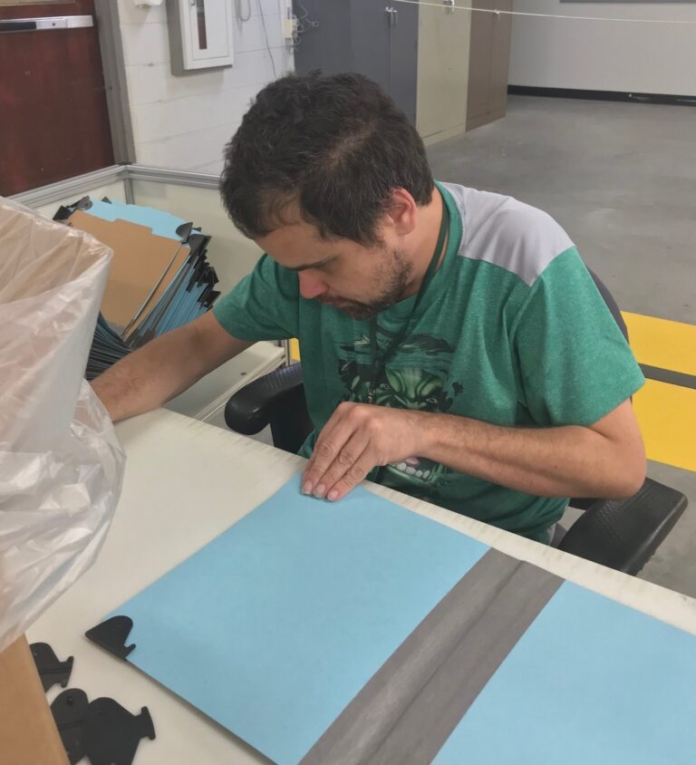 James working on a blue folder