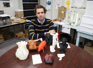 Sam Foulkes with 3-D printed objects.