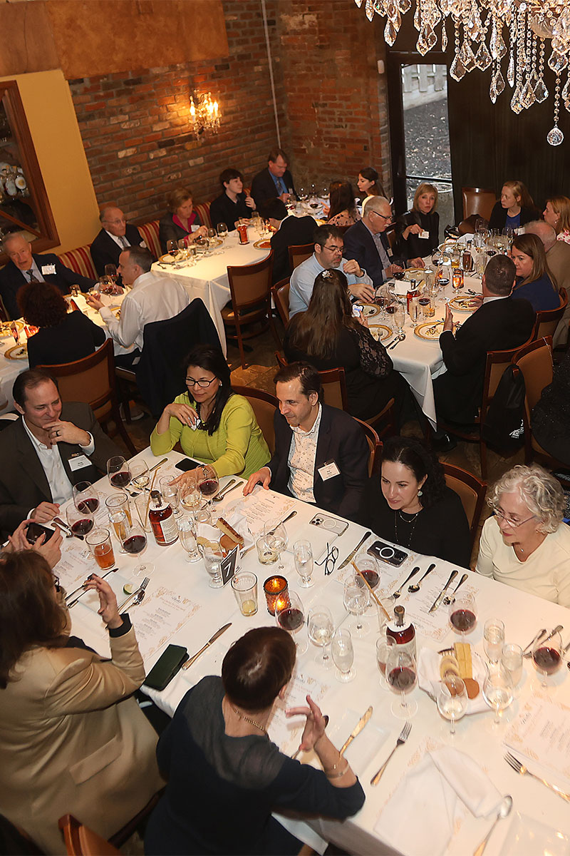 Many people are seated at tables for a fund raising dinner.