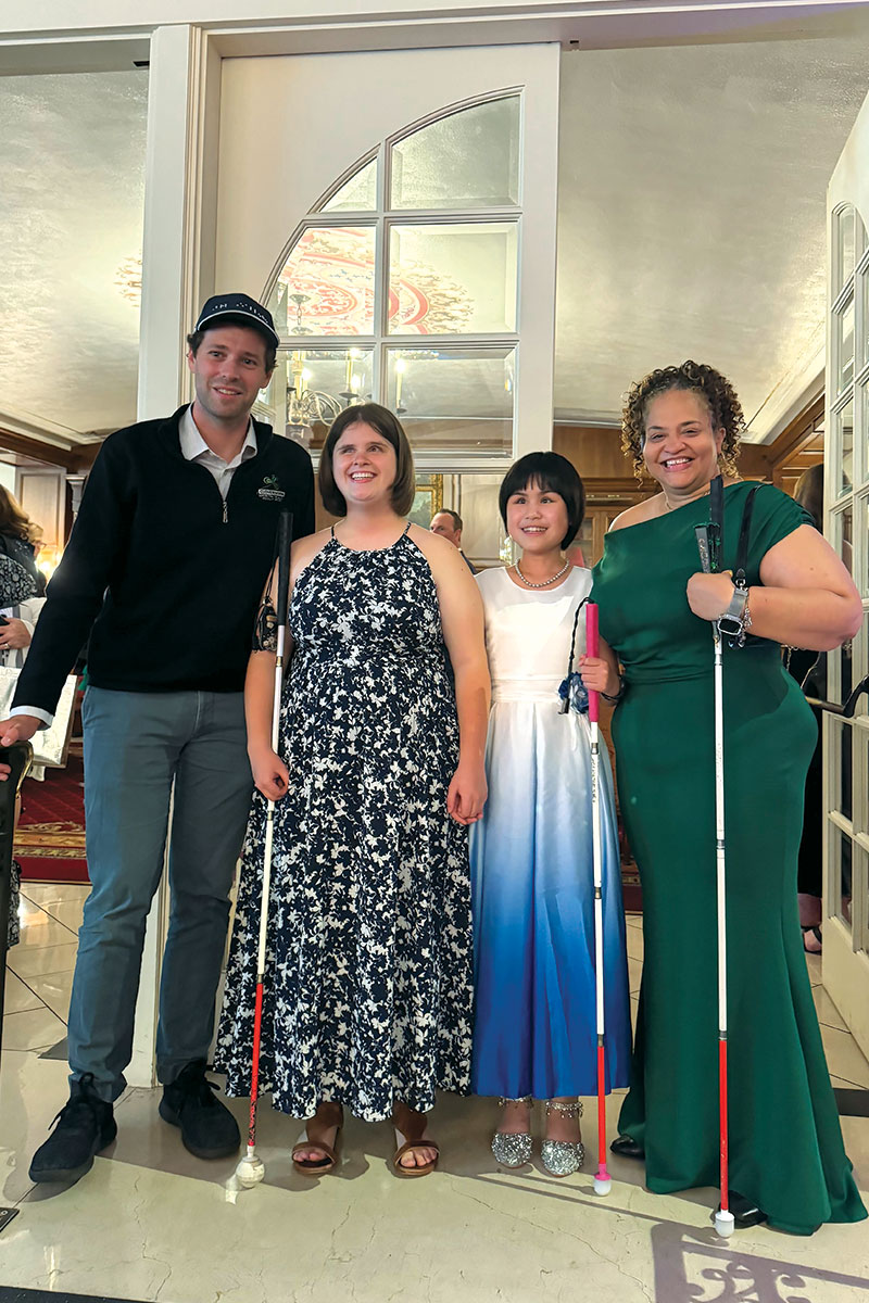High School senior, MaKenzie Love of Ashville, and sixth grade student Anne Ye of Lewis Center face pose for a picture with Samuel Foulkes and Stephanie Jones. All are wearing formal clothing to celebrate the Braille Challenge Finals Award Ceremony.
