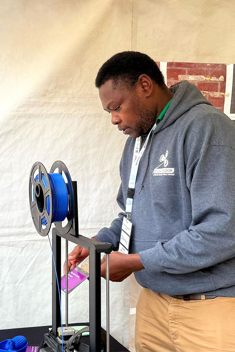 Dominic Kiamba, Clovernook Center’s Program Coordinator in Nairobi, demonstrates 3D printing.