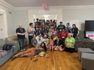 Anthony Ferraro poses smiling with a large group of people