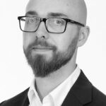 Austin Maynard smiles in a black and white portrait photo