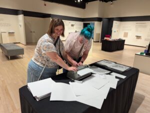 two visitors use the Brailler at the Tactile Revolutions exhibit at NKU